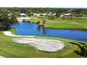 Scenic view of a lush green golf course with a tranquil pond and sand traps at 437 Cerromar Ln # 513, Venice, FL 34293