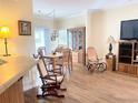 Cozy dining area with wood floors, dining table, chairs, and built-in cabinet space with natural light at 660 N Green Cir, Venice, FL 34285
