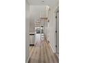 Hallway featuring a unique spiral staircase and plank flooring with views of an outdoor patio at 6800 Placida Rd # 280, Englewood, FL 34224