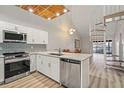 Modern kitchen with stainless steel appliances, granite countertops, white cabinetry, and unique ceiling detail at 6800 Placida Rd # 280, Englewood, FL 34224