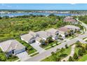 Beautiful aerial view of the home showcasing the lush landscaping and proximity to the serene lake at 8245 Grande Shores Dr, Sarasota, FL 34240