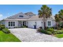 Charming home with a three-car garage, well-manicured landscaping, and a lovely paver driveway at 8245 Grande Shores Dr, Sarasota, FL 34240