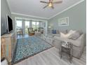 Charming living room filled with natural light, featuring a large sofa, stylish decor, and comfortable seating at 841 Waterside Dr # 202, Venice, FL 34285