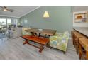 Cozy living room space with natural lighting with a dining room table and chairs next to a passthrough kitchen at 841 Waterside Dr # 202, Venice, FL 34285