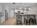 Well-lit kitchen featuring granite counters, stainless appliances, and a cozy breakfast bar at 903 E Shannon Ct, Venice, FL 34293
