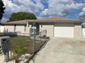 Charming single-story home featuring a decorative stone facade, long driveway, and well-maintained landscaping at 9110 Lunar Ln, Port Richey, FL 34668