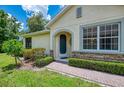 Charming home featuring a well-manicured lawn, lush landscaping, and a brick walkway at 9361 Carnaby Dr, Venice, FL 34293