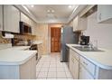 Well-maintained kitchen with stainless steel appliances, tiled floor, ample cabinet space, and modern finishes at 1290 Leeward Rd, Venice, FL 34293