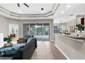 Open living room featuring access to outdoor area, breakfast bar and modern lighting at 2396 Caraway Dr, Venice, FL 34292