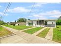 Street view of a well-kept house with a carport and neat lawn, set in a quiet neighborhood at 6111 Talbot St, North Port, FL 34287