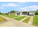 A charming one-story home with a carport and a well-manicured lawn, adding to its curb appeal at 6111 Talbot St, North Port, FL 34287
