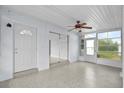 A spacious screened-in lanai with a ceiling fan, perfect for enjoying the outdoors comfortably at 6111 Talbot St, North Port, FL 34287