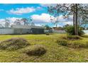 Spacious backyard featuring lush green grass, a white fence, and plenty of room for outdoor activities at 7585 Kavanda St, North Port, FL 34287