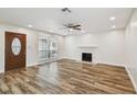 Bright and open living room features a fireplace, wood-look floors, and natural light at 7405 Clearview Dr, Tampa, FL 33634