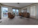 Living room with brown leather reclining furniture and a coffee table at 9155 Codel Loop, New Port Richey, FL 34654