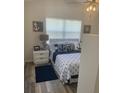 Bright bedroom with window seating and nautical-themed decor at 113 Red Cedar Park, Rotonda West, FL 33947