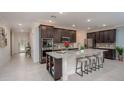 Modern kitchen with stainless appliances, an island, and a view of the front entrance at 25129 Calusa Dr, Punta Gorda, FL 33955