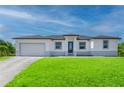 Inviting single story home with large green front lawn, two-car garage and covered porch at 15245 Brainbridge Circle, Port Charlotte, FL 33981