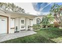 House exterior with welcoming front porch and landscaping at 10178 118Th Ave, Largo, FL 33773