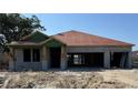 Under construction single-Gathering home showcasing a modern design, concrete block construction, and an attached two-car garage at 27092 Formosa Dr, Punta Gorda, FL 33983