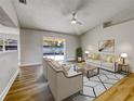 Living room with beige furniture and sliding glass doors at 865 Everest Rd, Venice, FL 34293