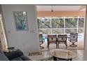 Bright living room with vaulted ceilings, comfortable seating, and tile flooring at 1 Long Meadow Ln, Rotonda West, FL 33947