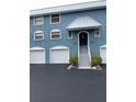 Three-unit building with attached garages and shared staircase at 12550 Capri N Cir # 3, Treasure Island, FL 33706