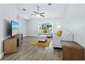 Bright living room with tile floors, comfy seating, and a large TV at 516 Casas Bonitas Way, Nokomis, FL 34275