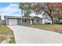 House exterior showcasing a grey painted exterior and long driveway at 4233 Oakfield Ave, Holiday, FL 34691