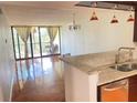 Combined kitchen and living room with granite countertops and polished concrete floors at 2424 W Tampa Bay Blvd # H103, Tampa, FL 33607