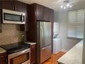 Modern kitchen with stainless steel appliances and granite countertops at 2424 W Tampa Bay Blvd # H103, Tampa, FL 33607