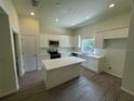 Modern kitchen with white cabinets, island, and stainless steel appliances at 5255 Farmington Ave, North Port, FL 34288