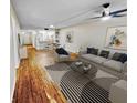 Open living room with hardwood floors and kitchen views at 1200 Tarpon Woods Blvd # S2, Palm Harbor, FL 34685
