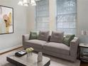 Bright living room featuring a comfy sofa and large windows at 8928 Red Beechwood Ct, Riverview, FL 33578