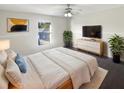 Relaxing bedroom featuring a comfortable queen-sized bed and modern decor at 30208 Rattana Ct, Wesley Chapel, FL 33545