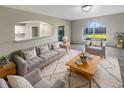 Comfortable living room with an arched window, plush sofa, and decorative rug at 30208 Rattana Ct, Wesley Chapel, FL 33545