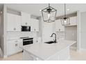 Modern kitchen with white cabinets and a large island at 522 Sun Chaser Dr, Nokomis, FL 34275
