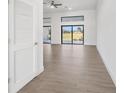 Bright and airy living room featuring floor-to-ceiling glass doors and sleek, contemporary tile flooring at 17261 Naiad Ct, Punta Gorda, FL 33955