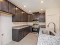 Well-equipped kitchen featuring granite countertops, stainless appliances, and ample storage at 5637 Ocarina Rd, North Port, FL 34291