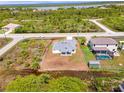 Aerial view of a new construction home with surrounding landscape at 10253 Calumet Blvd, Port Charlotte, FL 33981