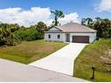 New construction home with a large driveway at 2138 Music Ln, North Port, FL 34286