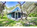 Blue house with screened porch and yard at 34392 Broken Stone St, Webster, FL 33597