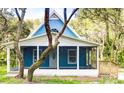 Charming blue house with a screened porch at 34392 Broken Stone St, Webster, FL 33597