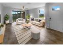 Cozy living room with tile floors, neutral paint, and stylish furniture, creating an inviting and comfortable atmosphere at 33083 Windelstraw Dr, Wesley Chapel, FL 33545