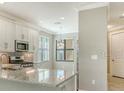 Spacious kitchen with an island, stainless steel appliances, and granite countertops at 4915 Carova Way, Lakewood Ranch, FL 34211