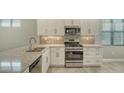 Modern kitchen featuring stainless steel appliances and granite countertops at 4915 Carova Way, Lakewood Ranch, FL 34211