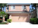 This two-story home offers a convenient two-car garage and a manicured front yard at 11774 Tempest Harbor Loop, Venice, FL 34292