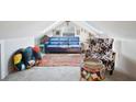 Bright loft area with a blue couch, patterned armchair, and colorful rug at 117 88Th Ave, Treasure Island, FL 33706