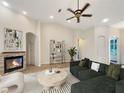 Spacious living room with fireplace, hardwood floors, and large windows at 2513 Andrea Lynn Dr, Lutz, FL 33549