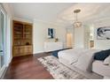 Main bedroom with hardwood floors, built-in shelving, and an ensuite bathroom at 2513 Andrea Lynn Dr, Lutz, FL 33549